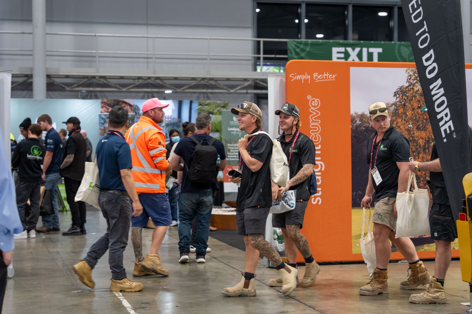 Landscapers walking the show floor with show bags