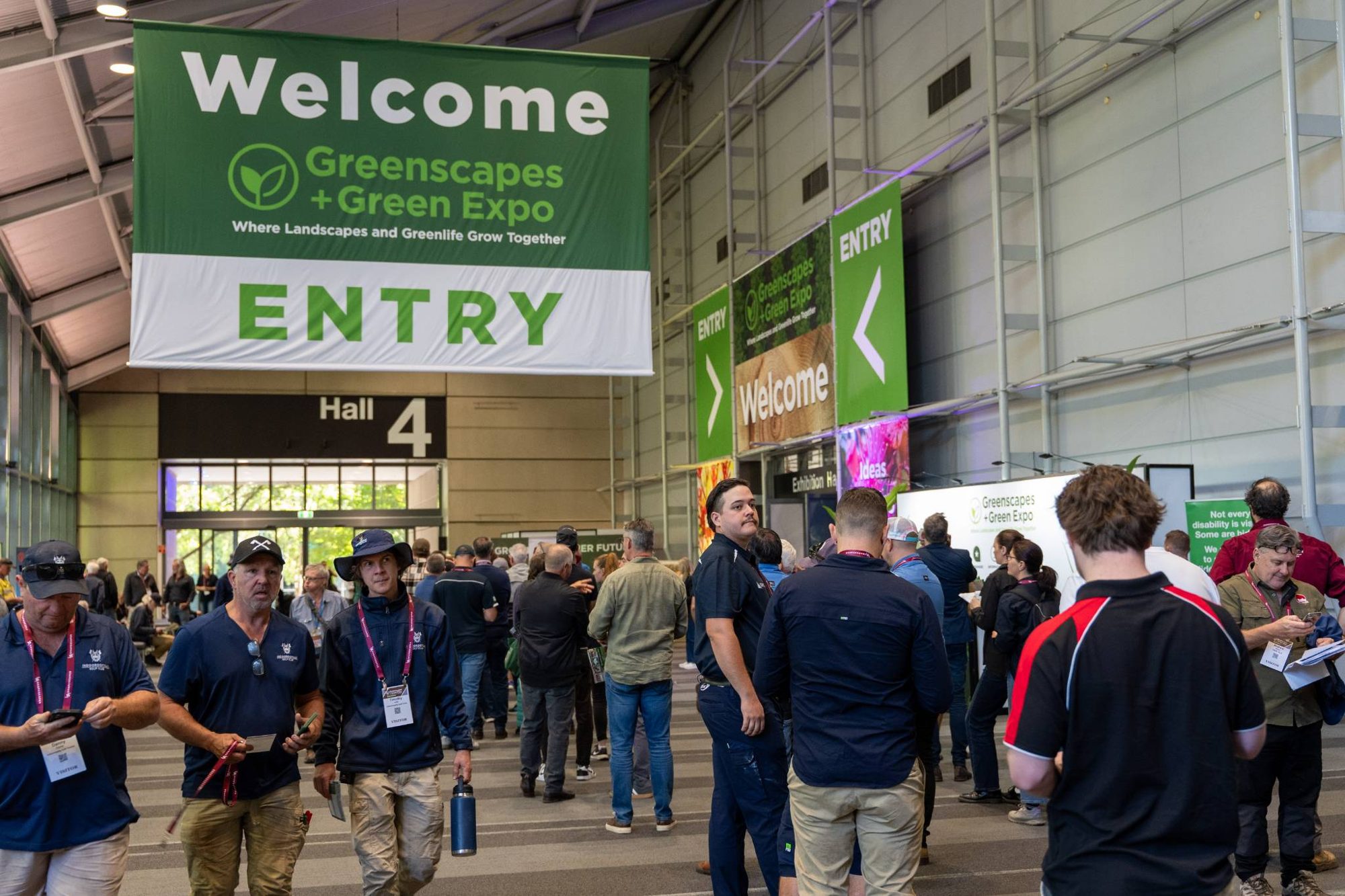 Visitors arriving under the Greenscapes + Green Expo welcome and entry signs