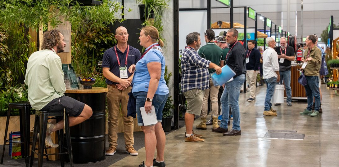 Visitors meeting exhibitors in a busy aisle