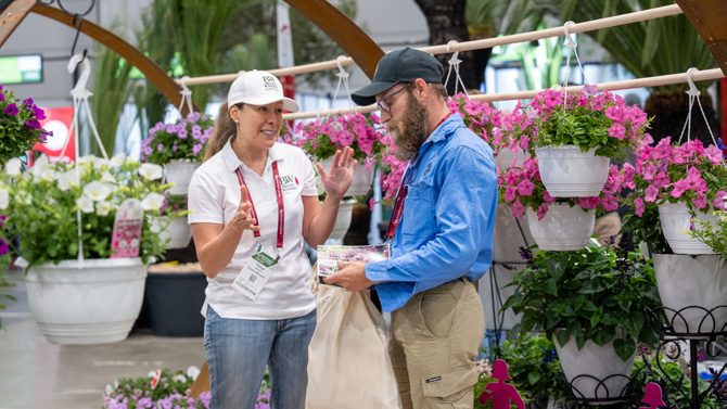 Visitors browsing potted plants